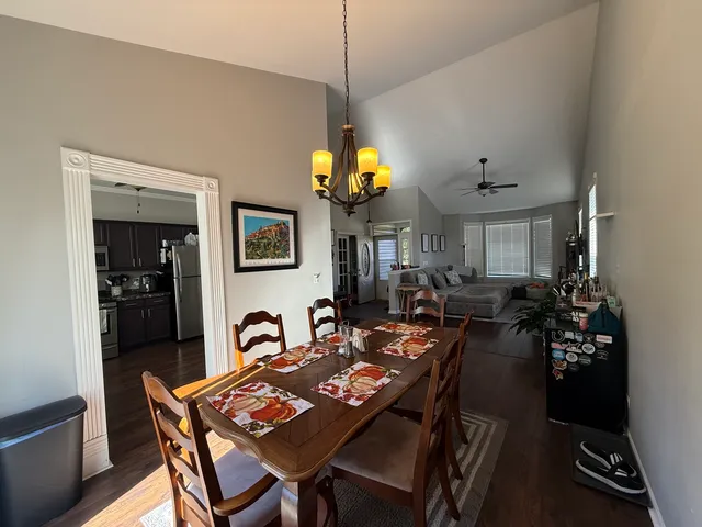 a view of a dining room with furniture and a chandelier