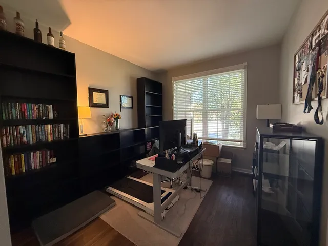 a living room with furniture bookshelf and a window