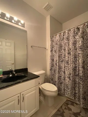 a bathroom with a toilet a sink and a shower