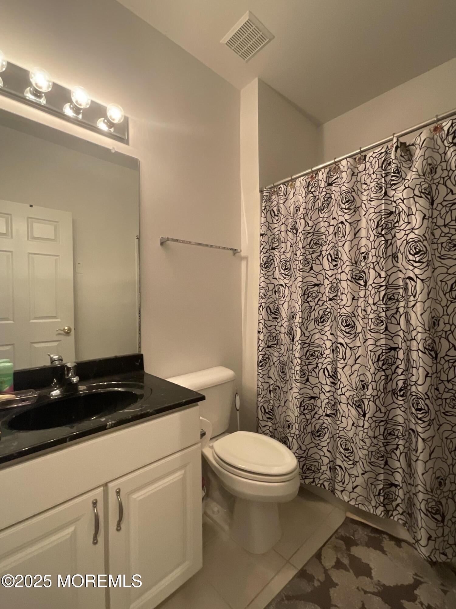 6 Ravenna Road Manchester Township, NJ 08759 - Photo 11 of 14 a bathroom with a toilet a sink and a shower