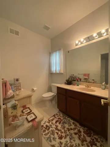 a bathroom with a sink toilet and mirror