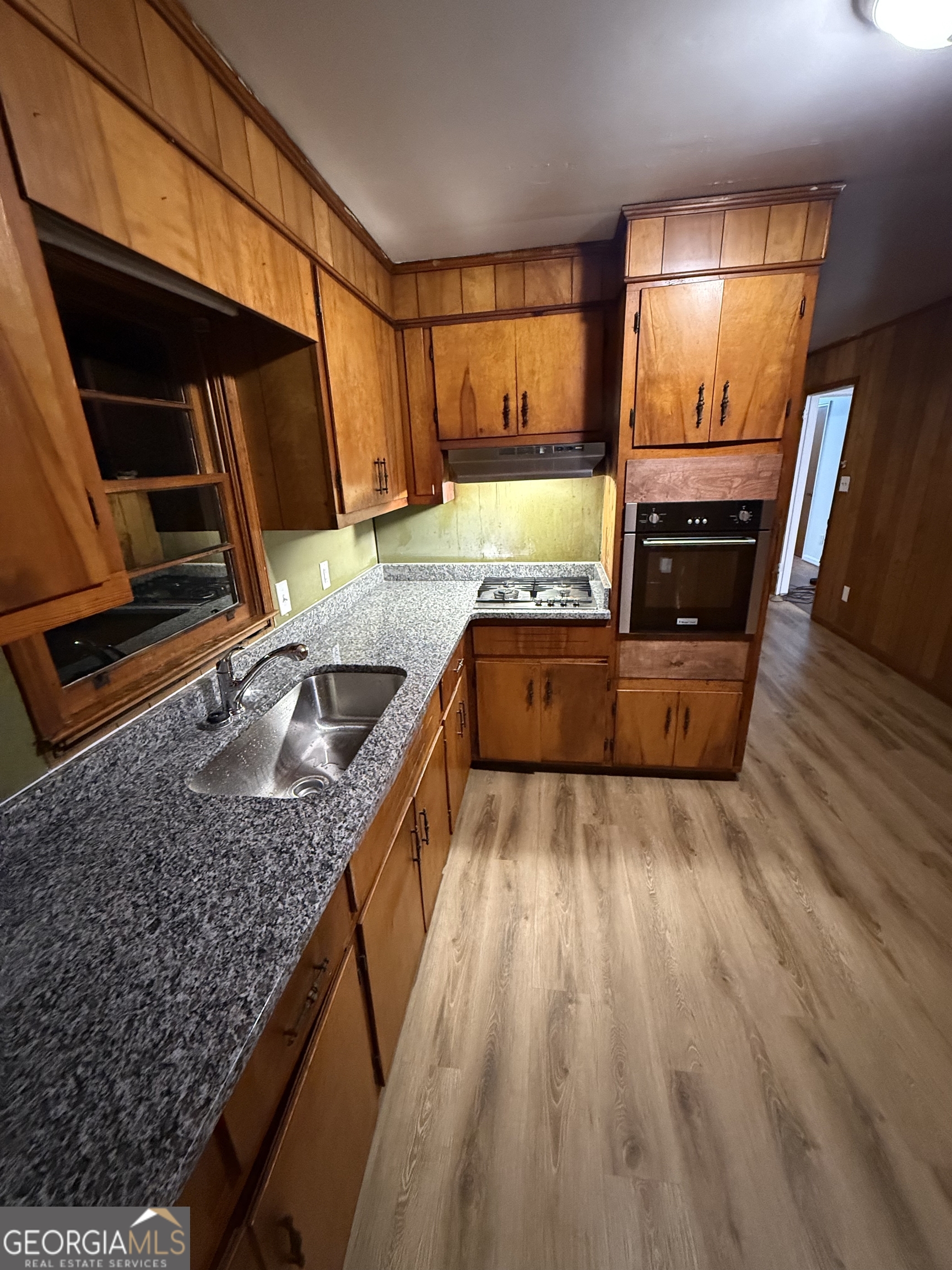 193 Brownlee Road Jackson, GA 30233 - Photo 4 of 10 a kitchen with sink a refrigerator and wooden floor