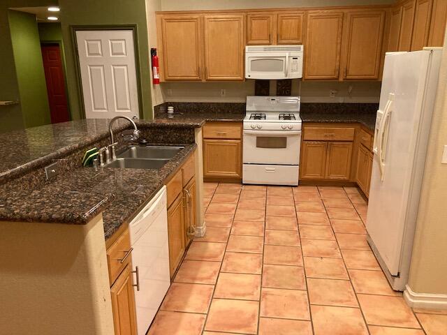 48192 Panorama Avenue Indio, CA 92201 - Photo 19 of 47 a kitchen with granite countertop a stove a sink and a refrigerator