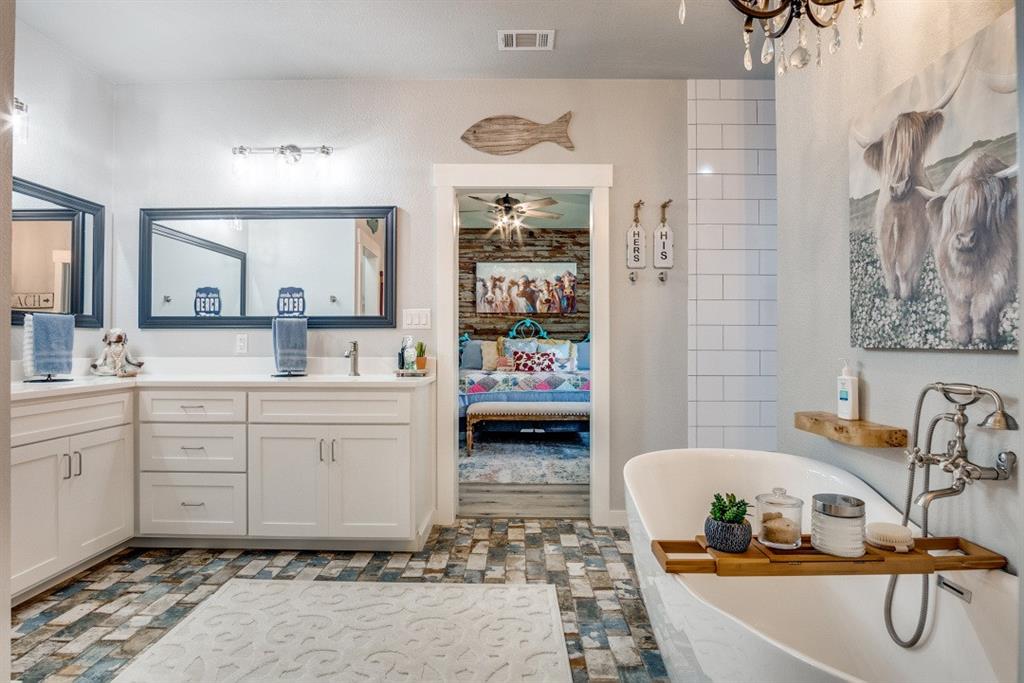 385 Brown Road Palo Pinto, TX 76484 - Photo 12 of 18 a bathroom with a sink double vanity and a tub