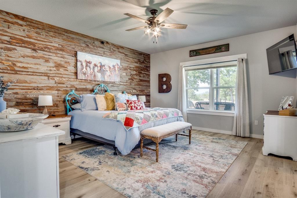 385 Brown Road Palo Pinto, TX 76484 - Photo 10 of 18 a bed room with a bed and a window