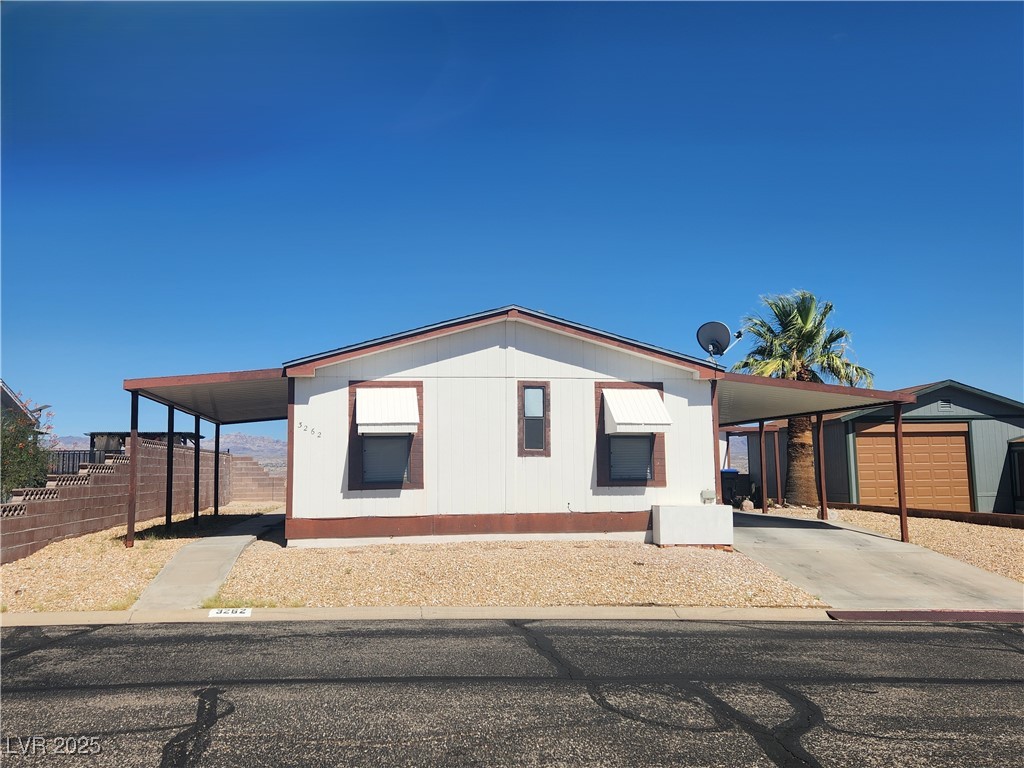 3262 Del Monte Street Laughlin, NV 89029 - Photo 3 of 42 Manufactured / mobile home featuring an attached carport and concrete driveway