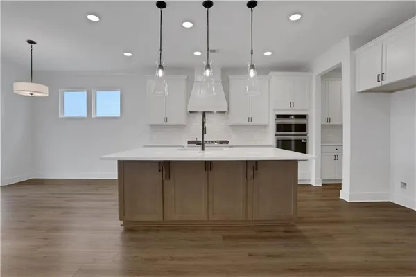 a kitchen with a sink stainless steel appliances and cabinets