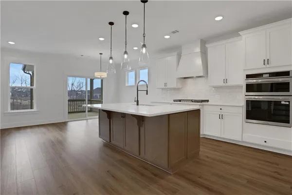 a view of white cabinets and wooden floor
