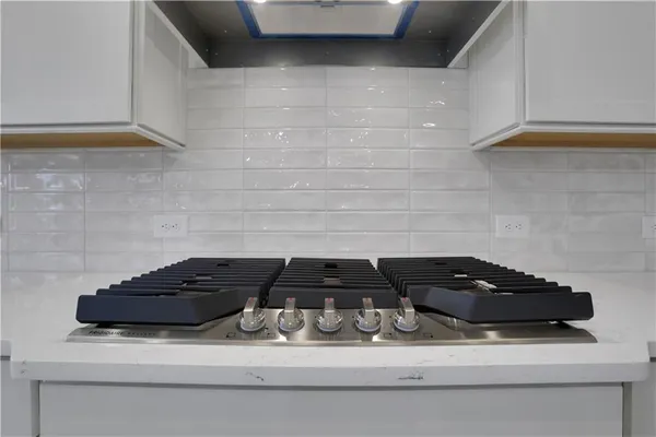 a view of a kitchen with wooden floor and a window