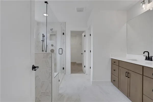 a view of empty room with wooden floor and ceiling fan