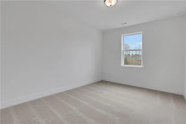 an aerial view of a house with a yard and lake view