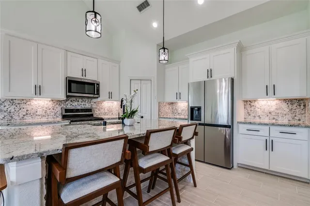 a kitchen with refrigerator cabinets and furniture