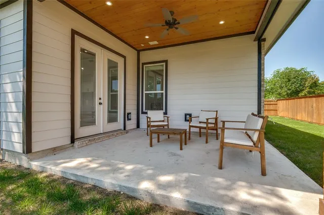 a view of an chairs and tables in the back yard