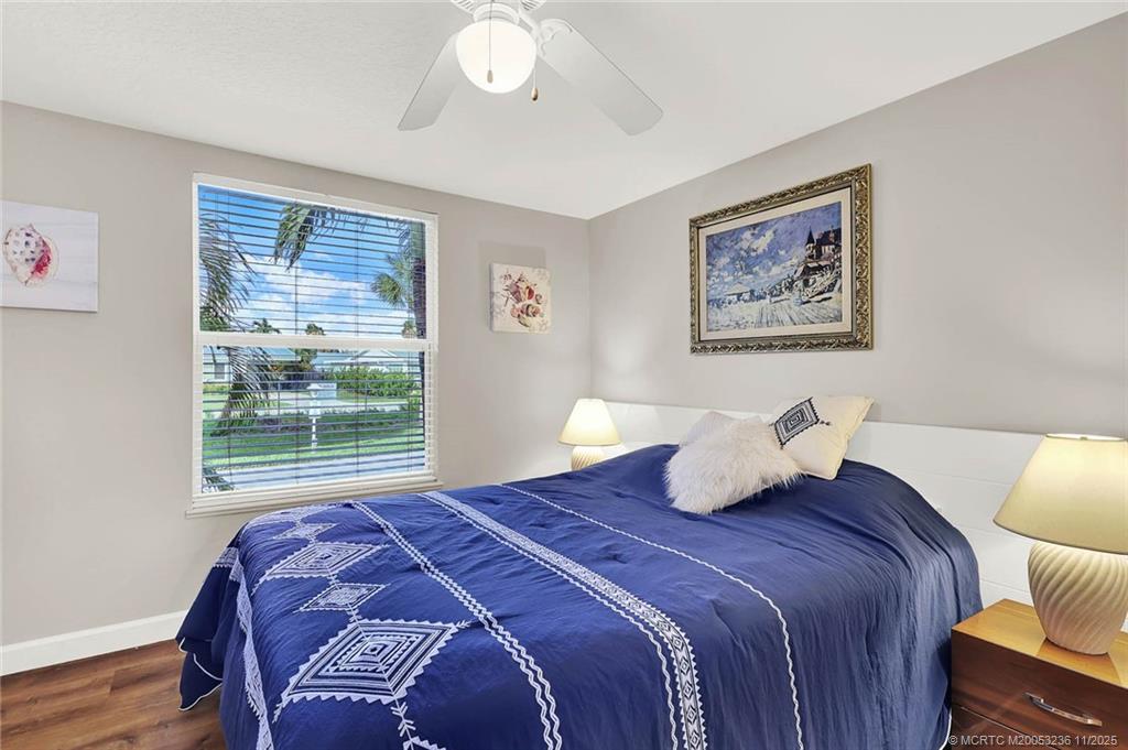 10701 South Ocean Drive, Unit 855 Jensen Beach, FL 34957 - Photo 11 of 67 a bedroom with a bed and a painting on the wall