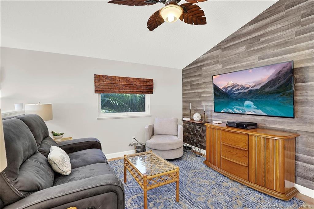 10701 South Ocean Drive, Unit 855 Jensen Beach, FL 34957 - Photo 24 of 67 a living room with furniture and a flat screen tv