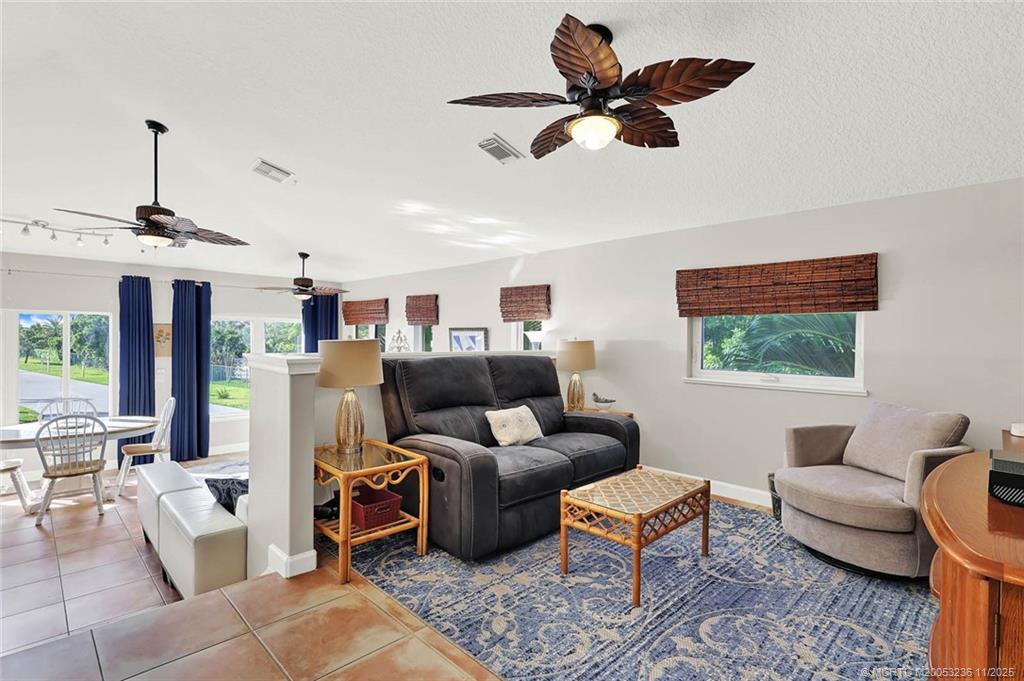 10701 South Ocean Drive, Unit 855 Jensen Beach, FL 34957 - Photo 25 of 67 a living room with furniture ceiling fan and a rug