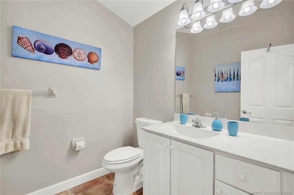 10701 South Ocean Drive, Unit 855 Jensen Beach, FL 34957 - Photo 28 of 67 a bathroom with a sink a toilet and a mirror
