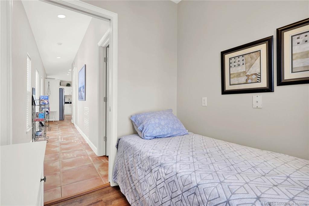 10701 South Ocean Drive, Unit 855 Jensen Beach, FL 34957 - Photo 31 of 67 a bedroom with a large bed and a wooden floor