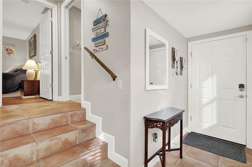 10701 South Ocean Drive, Unit 855 Jensen Beach, FL 34957 - Photo 9 of 67 a view of a hallway with entryway wooden floor and front door