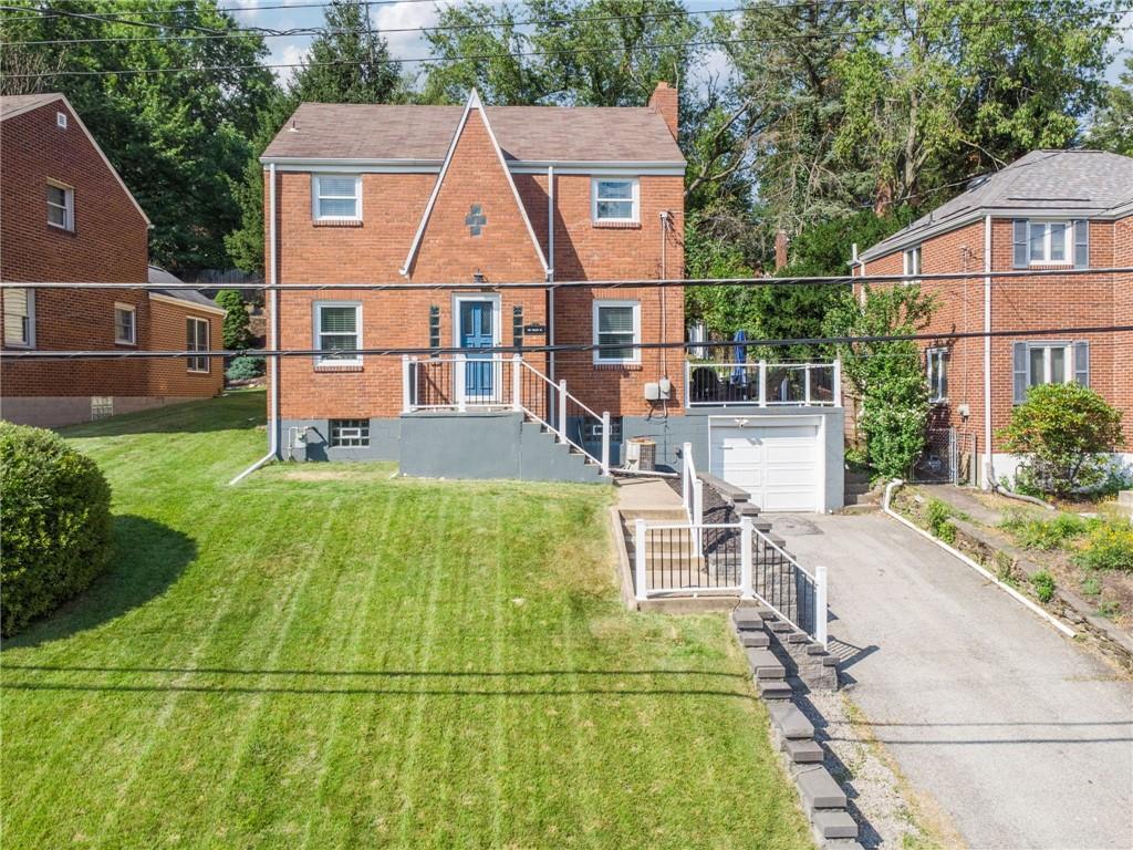 an aerial view of a house with swimming pool and porch