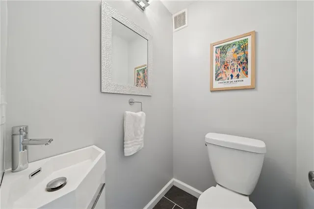 a white toilet sitting next to a bathroom sink