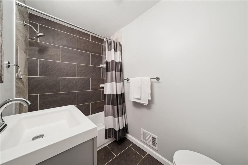 2415 Collins Road Pittsburgh, PA 15235 - Photo 26 of 32 a bathroom with a sink a toilet and shower