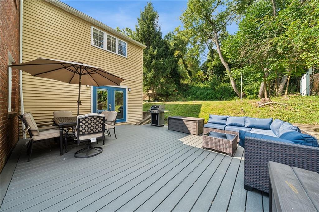 2415 Collins Road Pittsburgh, PA 15235 - Photo 29 of 32 a view of a patio with dining table and chairs with wooden floor and fence