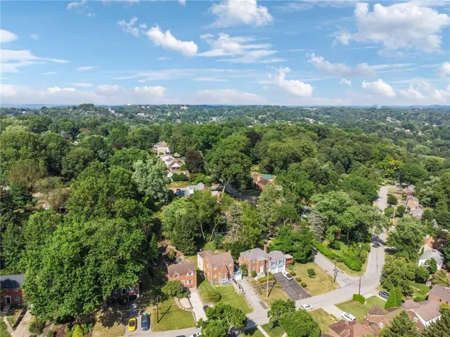 an aerial view of a houses with yard
