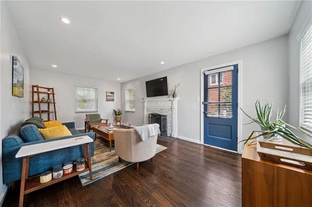 a living room with furniture fireplace and a window