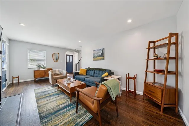 a living room with furniture and wooden floor