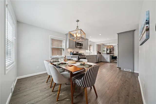 a view of a a dining room with furniture window and wooden floor