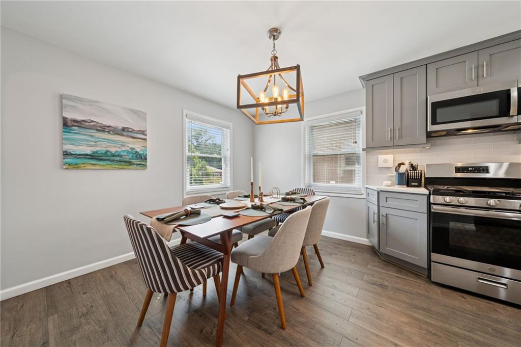 2415 Collins Road Pittsburgh, PA 15235 - Photo 9 of 32 a view of a dining room with furniture a chandelier and wooden floor