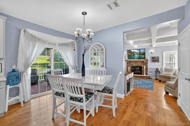 a view of a dining room with furniture wooden floor and chandelier