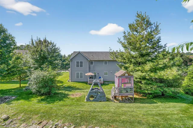 a view of house with yard