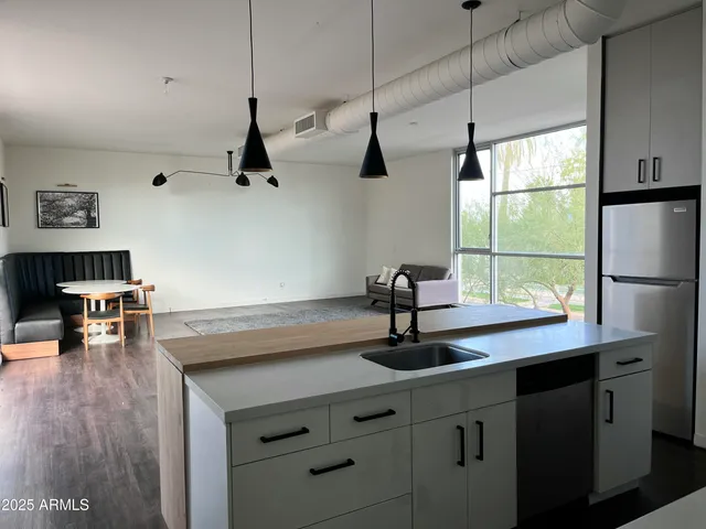 a view of a kitchen with a sink wooden floor and a window