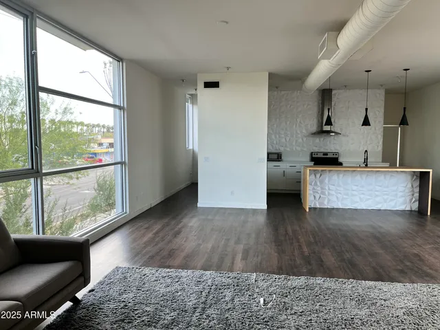 a view of a room with wooden floor and a window