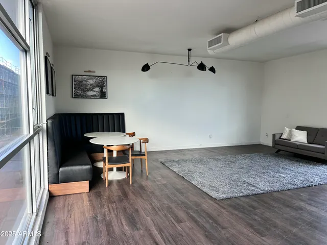 a view of a room with furniture window and wooden floor