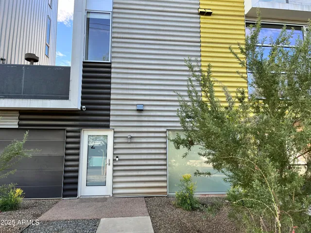 a view of a street with potted plants