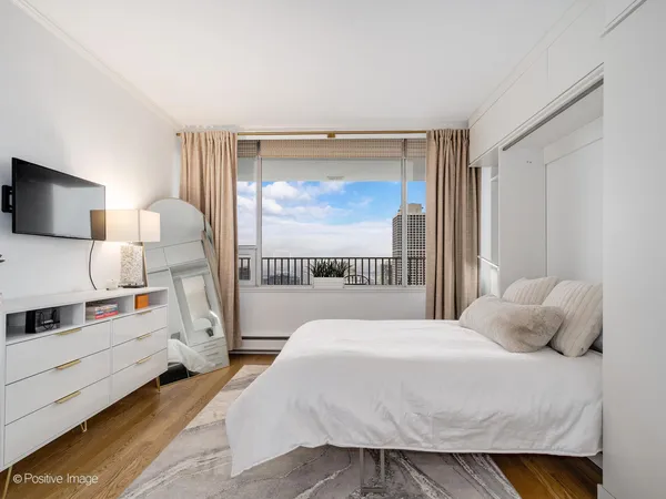 a bedroom with a bed and a window with outer view