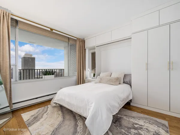 a view of a room with wooden floor and a window