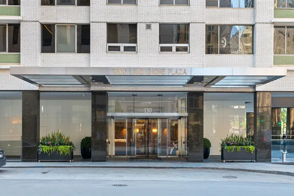 a front view of a building with a garden