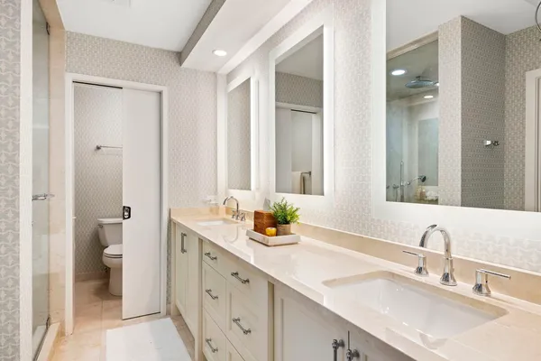 a bathroom with a double vanity sink and