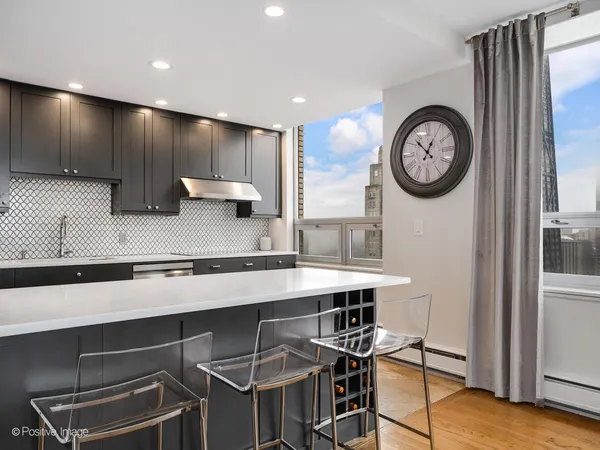 a view of a kitchen with a table and a clock