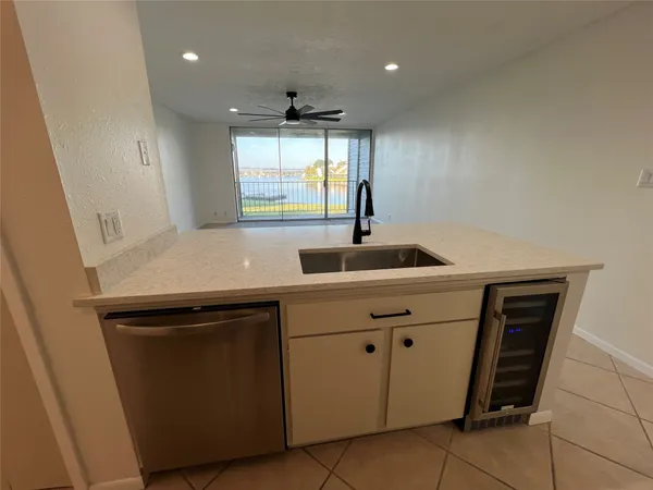 a kitchen with kitchen island a sink appliances and cabinets
