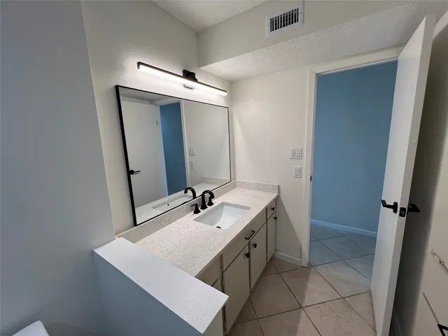 a bathroom with a sink a vanity and a mirror