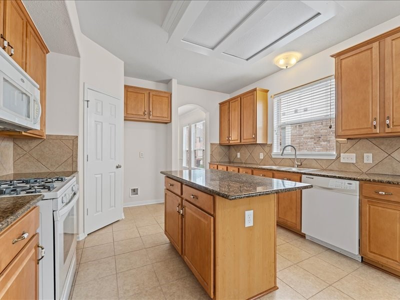 3323 Sainte Mere Eglise Lane Spring, TX 77388 - Photo 14 of 33 a kitchen with stainless steel appliances granite countertop a stove a sink and a refrigerator