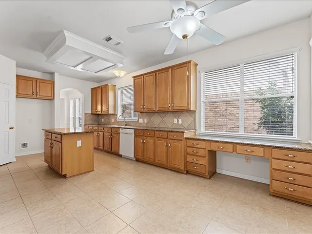 a large kitchen with a large window cabinets and stainless steel appliances