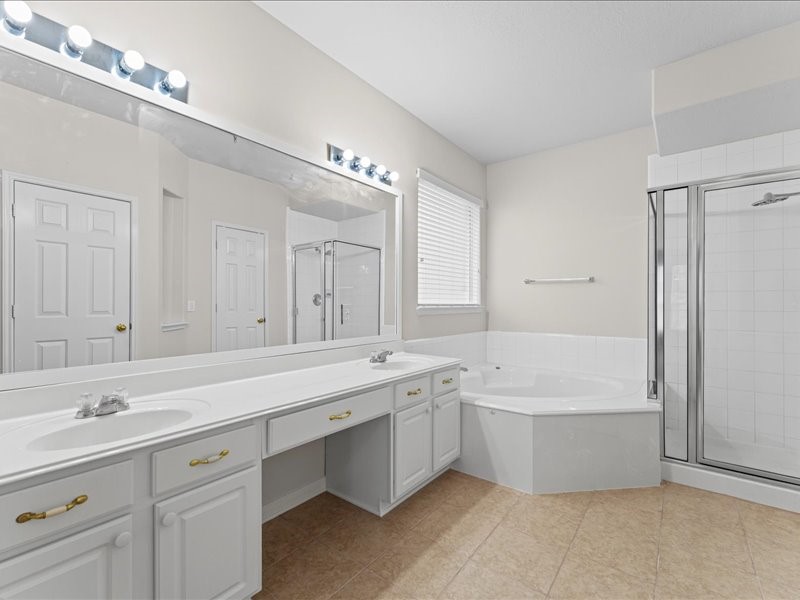 3323 Sainte Mere Eglise Lane Spring, TX 77388 - Photo 18 of 33 a spacious bathroom with a tub double sink and mirror