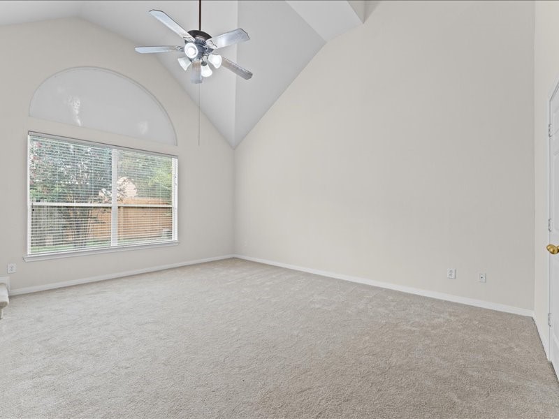 3323 Sainte Mere Eglise Lane Spring, TX 77388 - Photo 20 of 33 en empty room with windows and ceiling fan