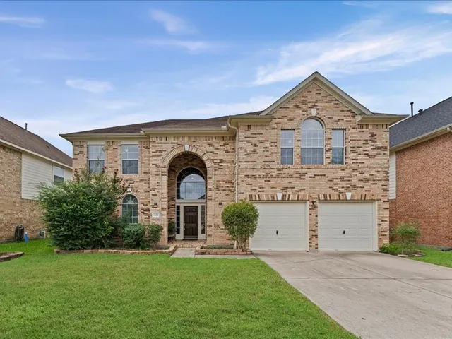front view of a house with a garden